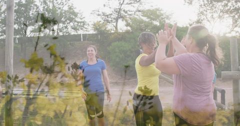 Women Celebrating Success at Outdoor Obstacle Course
