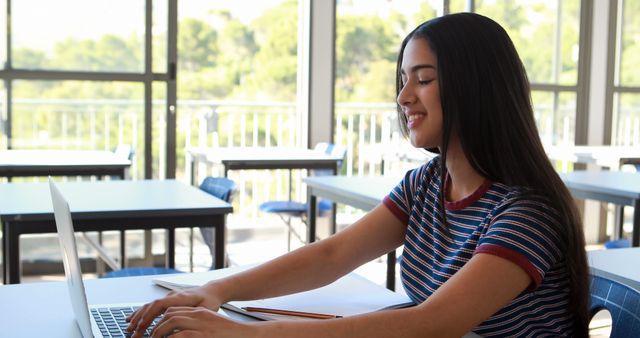 Smiling Teenage Girl Using Laptop for Online Learning in Classroom - Download Free Stock Images Pikwizard.com