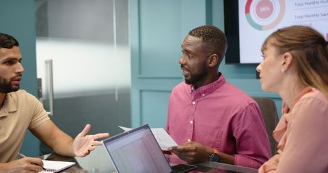 Multiracial Team Collaborating in Office Meeting with Technology