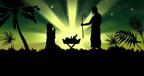 Silhouette nativity scene under starry green sky