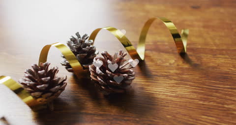 Pine Cones with Golden Ribbon on Rustic Wooden Table