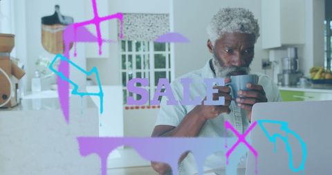 Elderly Man Shopping Online with Sale Banner Displayed