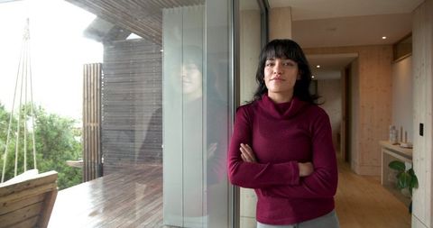Confident Hispanic Woman Relaxing at Home in Modern Interior