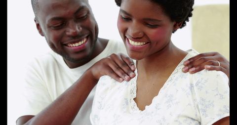 Joyful Couple Sharing a Light-Hearted Moment with Laughter