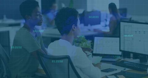 Colleagues collaborating over data dashboards, spreadsheets and analytics in open office