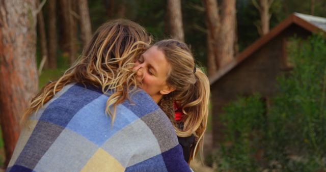 Romantic couple embracing each other in the forest. Couple wrapped in blanket 4k