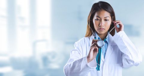 Asian Female Doctor Adjusting Stethoscope in Hospital - Download Free Stock Images Pikwizard.com