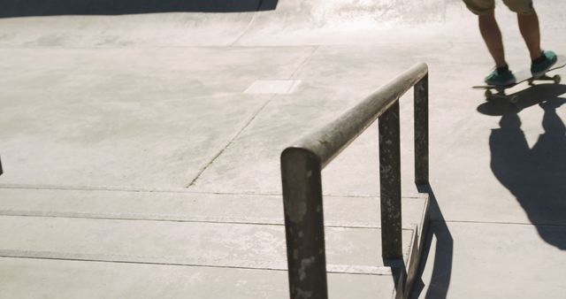 Features skateboarder on concrete surface in urban skatepark, showcasing the sport's culture and lifestyle. Useful for themes related to extreme sports, youth activities, outdoor hobbies, and leisure interests.