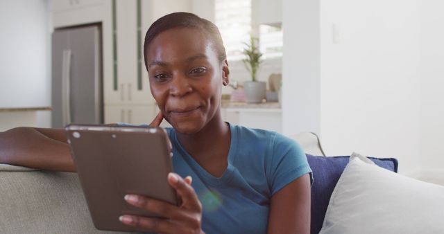 Smiling Woman Enjoying Tablet in Comfortable Living Room - Download Free Stock Images Pikwizard.com