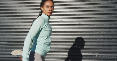Woman Stretching Outdoors in Sunny Urban Environment - Download Free Stock Images Pikwizard.com