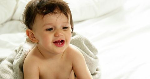 Smiling Baby Sitting Indoors on Soft Blanket - Download Free Stock Images Pikwizard.com
