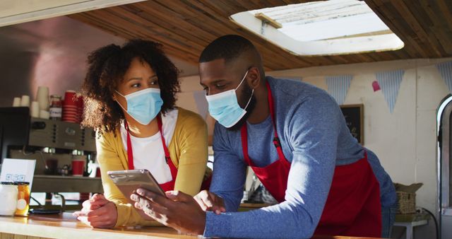 Couple Behind Food Truck Counter Wearing Masks Using Tablet - Download Free Stock Images Pikwizard.com