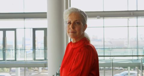 Confident senior businesswoman in modern office setting