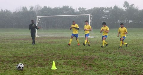 Soccer coach leading warm-up session for focused team training