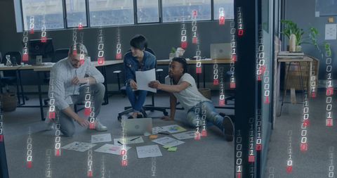 Diverse team analyzing data amidst binary code overlay in modern office