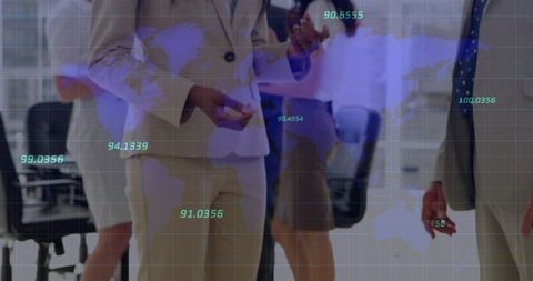 Business team wearing suits and blazers collaborating over digital global map in modern office