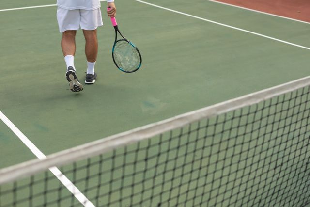 This photo can be used for promoting healthy lifestyles, advertising sports equipment, illustrating blog articles about tennis, or creating content about outdoor hobbies and leisure activities.