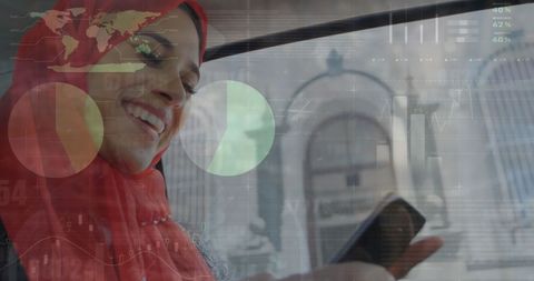 Smiling Woman in Hijab Connecting with Global Financial Data on Smartphone
