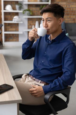 Professional Man Drinking Coffee in Modern Office Environment