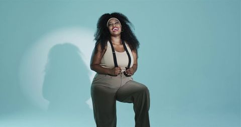 Confident african american woman laughing with suspenders