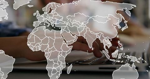 Hands typing on laptop with world map overlay representing global remote collaboration