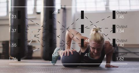 Data integration and fitness: woman performing press-ups with medicine ball