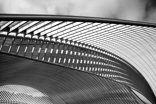Sleek Metal Architecture Against Cloudy Sky in Black and White - Download Free Stock Photos Pikwizard.com