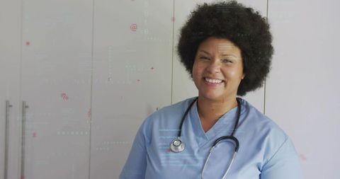 Smiling nurse wearing blue scrubs and stethoscope promoting modern clinical care