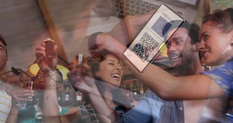 Friends Celebrating with Smartphone QR Code for Vaccination Pass