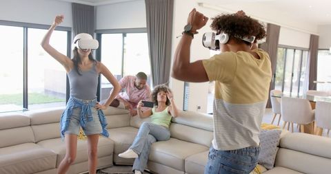 Diverse Friends Gaming with VR Headsets in Cozy Living Room