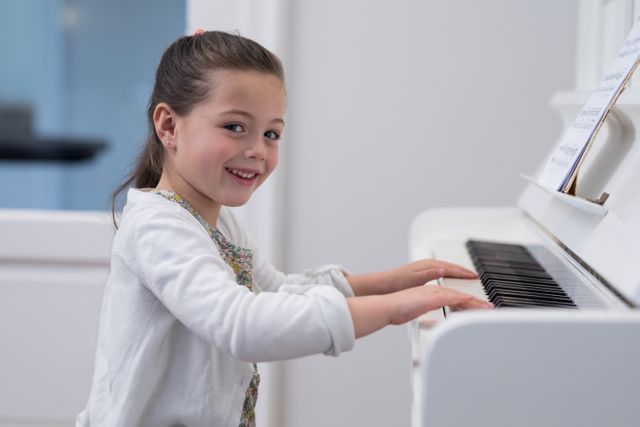 Smiling Girl Playing Piano at Home - Download Free Stock Photos Pikwizard.com