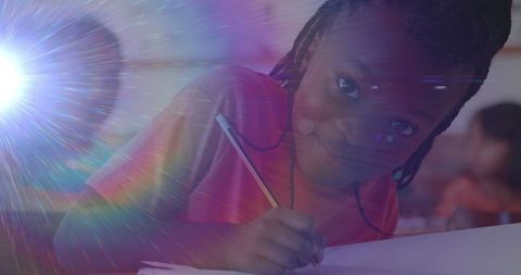 Smiling Schoolgirl Writing at School Desk with Bright Lens Flare