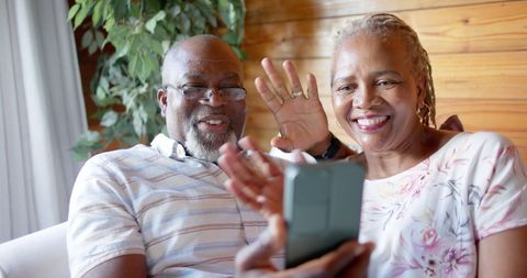 Senior Couple Enjoying Video Call on Sofa in Cozy Living Room