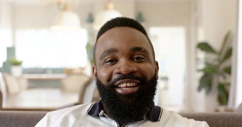 Smiling Man Relaxed at Home in Modern Living Room