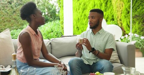 African American Couple Enjoying Drinks on Outdoor Patio