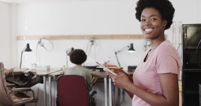 Smiling Woman in Workshop Holding Digital Tablet - Download Free Stock Images Pikwizard.com