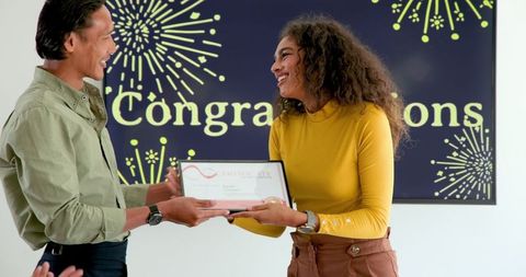 Cheerful colleagues celebrating achievement during award ceremony