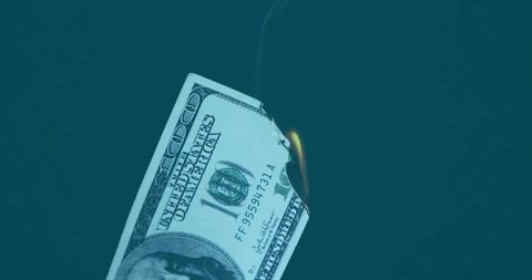 Burning hundred dollar bill illustrating financial risk