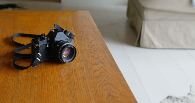 Classic Camera Lying On Wooden Table in Bright Living Room - Download Free Stock Images Pikwizard.com