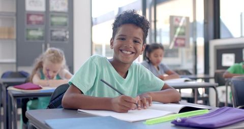 Smiling Boy Learning in Classroom Setting - Download Free Stock Images Pikwizard.com