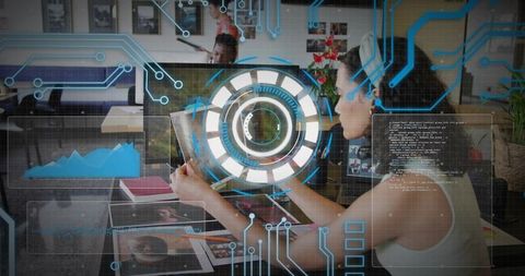 Woman analyzing tablet with futuristic interface in collaborative open-plan office