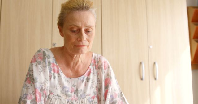 Elderly Woman Reflecting in Floral Dress at Home - Download Free Stock Images Pikwizard.com