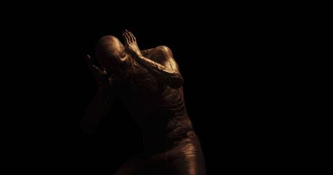 this concept art depicts a figure appearing distressed and holding its head as if in agony. the somber setting with dark shadows emphasizes feelings of fear and horror. useful for illustrating themes of inner torment, psychological struggle, or unsettling emotion in creative or narrative projects.