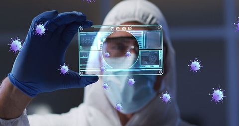 Scientist analyzing digital data with coronavirus icons