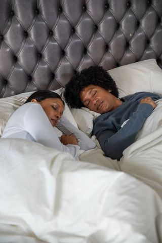 Serene african american couple sleeping peacefully