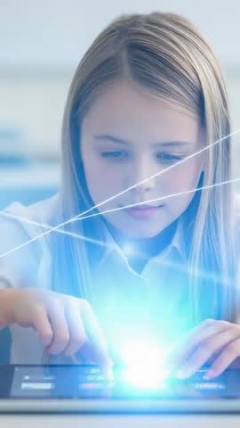 Girl interacting with tablet creating glowing blue holographic orb in classroom vertical video