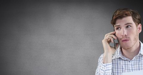 Businessman on Smartphone with Pensive Expression
