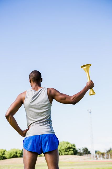 Athlete holding a fire torch - Download Free Stock Photos Pikwizard.com