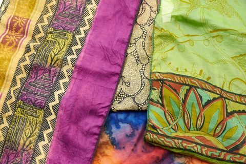 Displaying vibrant silk scarves with bohemian prints, paisley motifs and floral borders