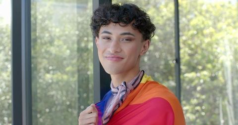 Person embracing lgbtq pride with rainbow flag